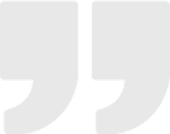 Gray quotation marks on a black background.